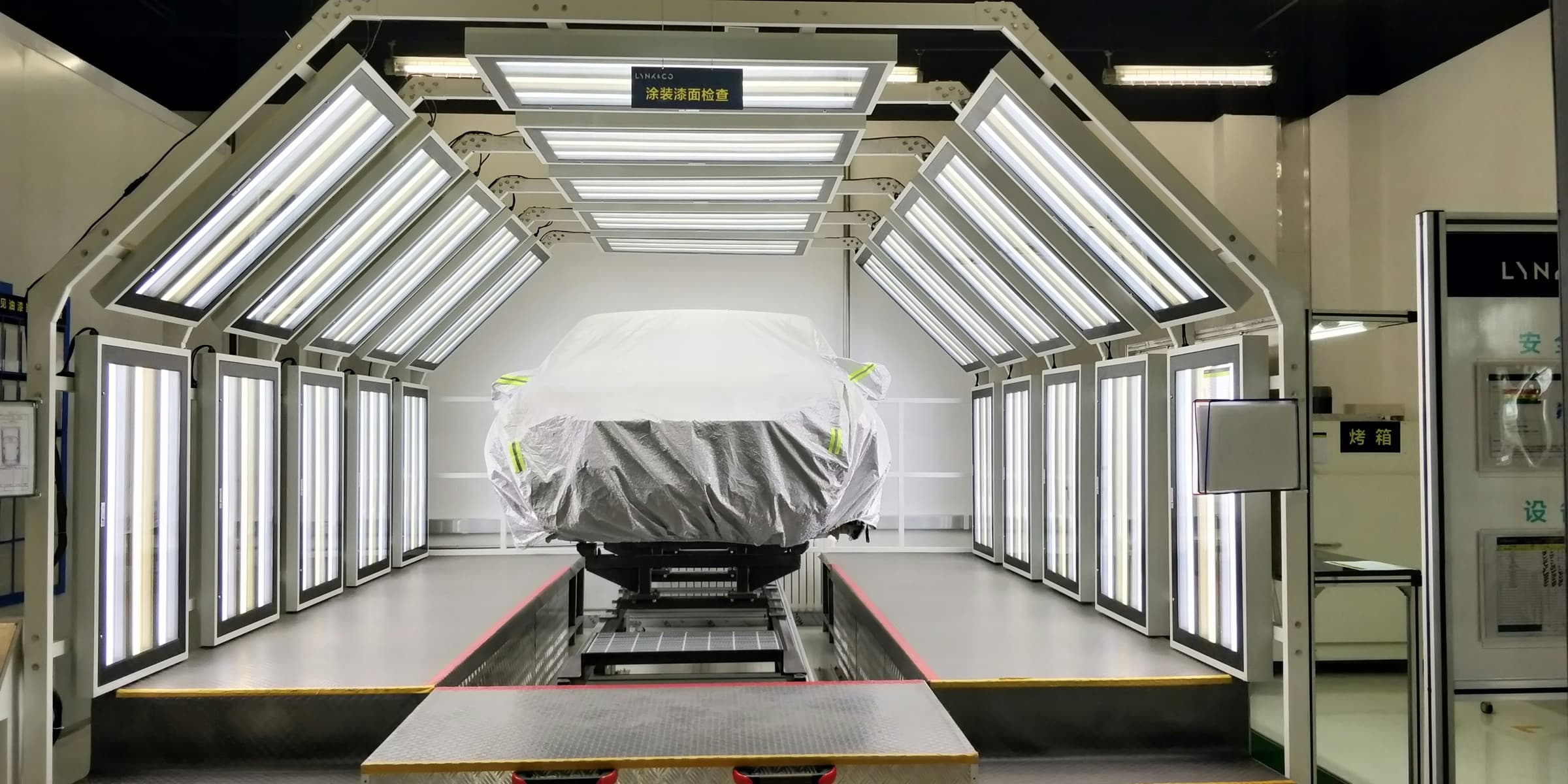 Vehicle inside an illuminated engineering inspection chamber, used as illustrative photography